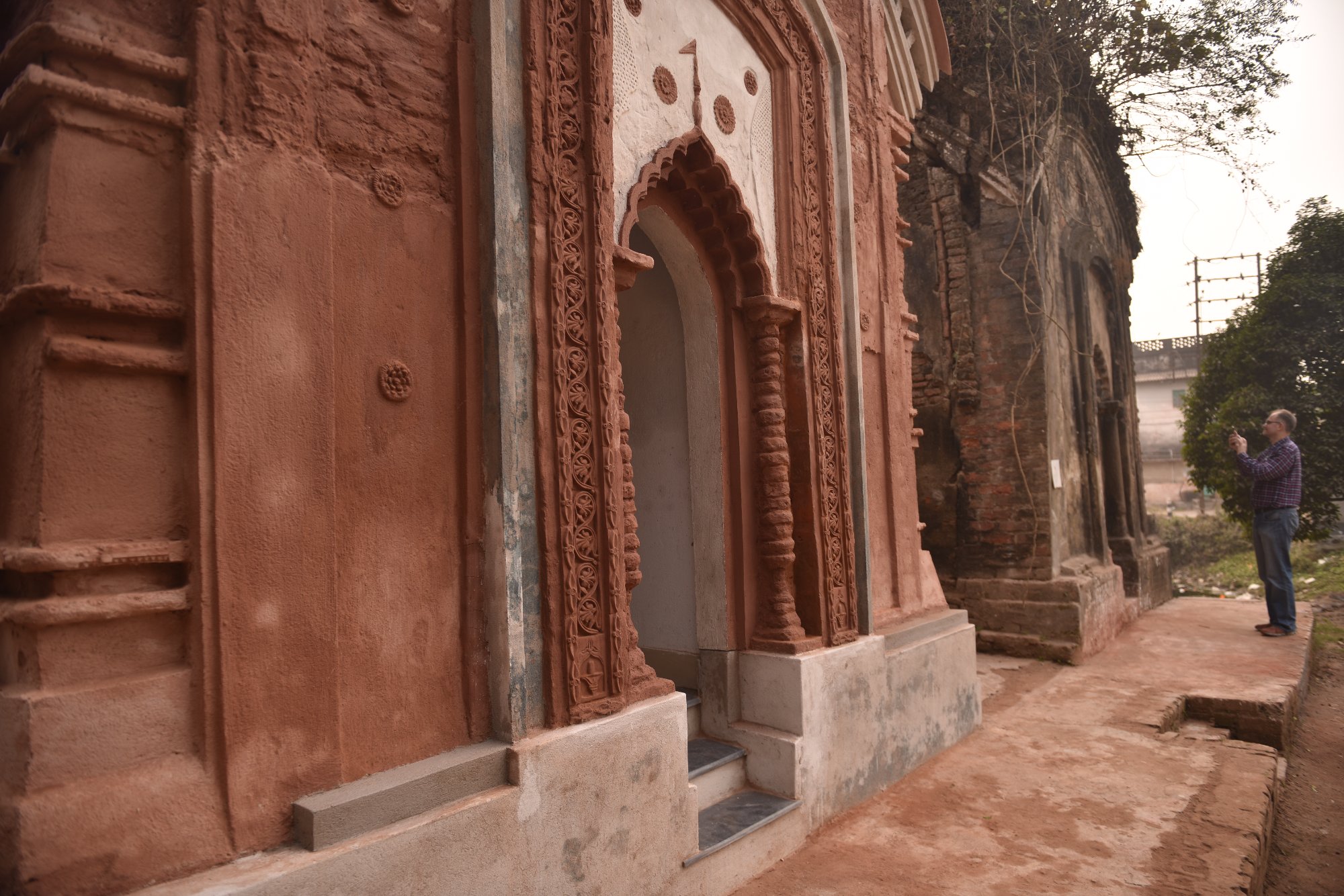 Carved terracotta column and decorative panel — close-up of restored craft