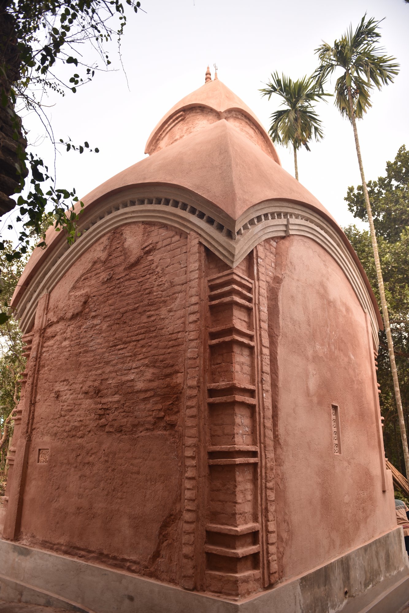 Ornate terracotta doorway arch with carved decorations — restored detail