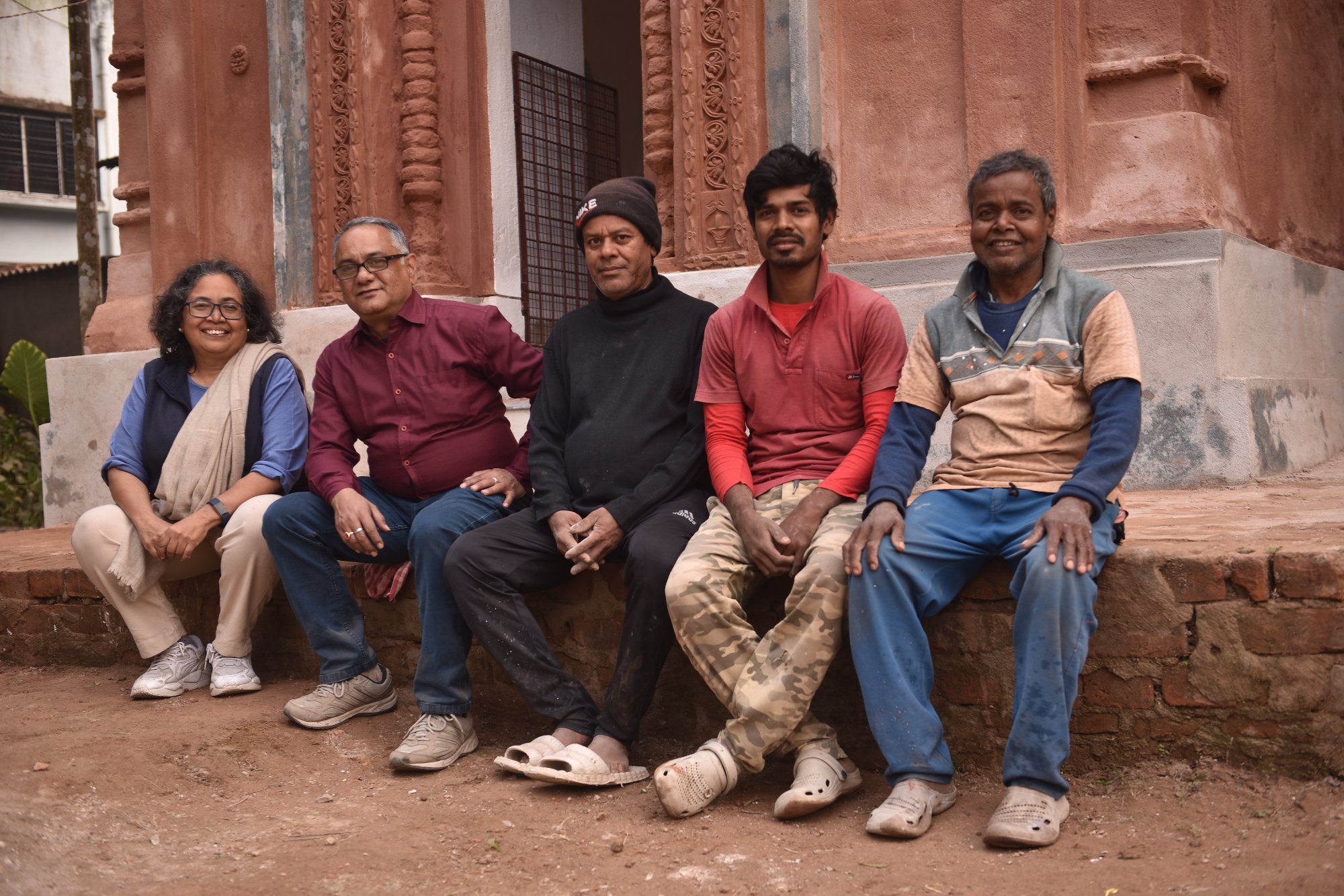 Team at the temple — Dr. Neeta Das and conservation team sitting in front of the restored temple
