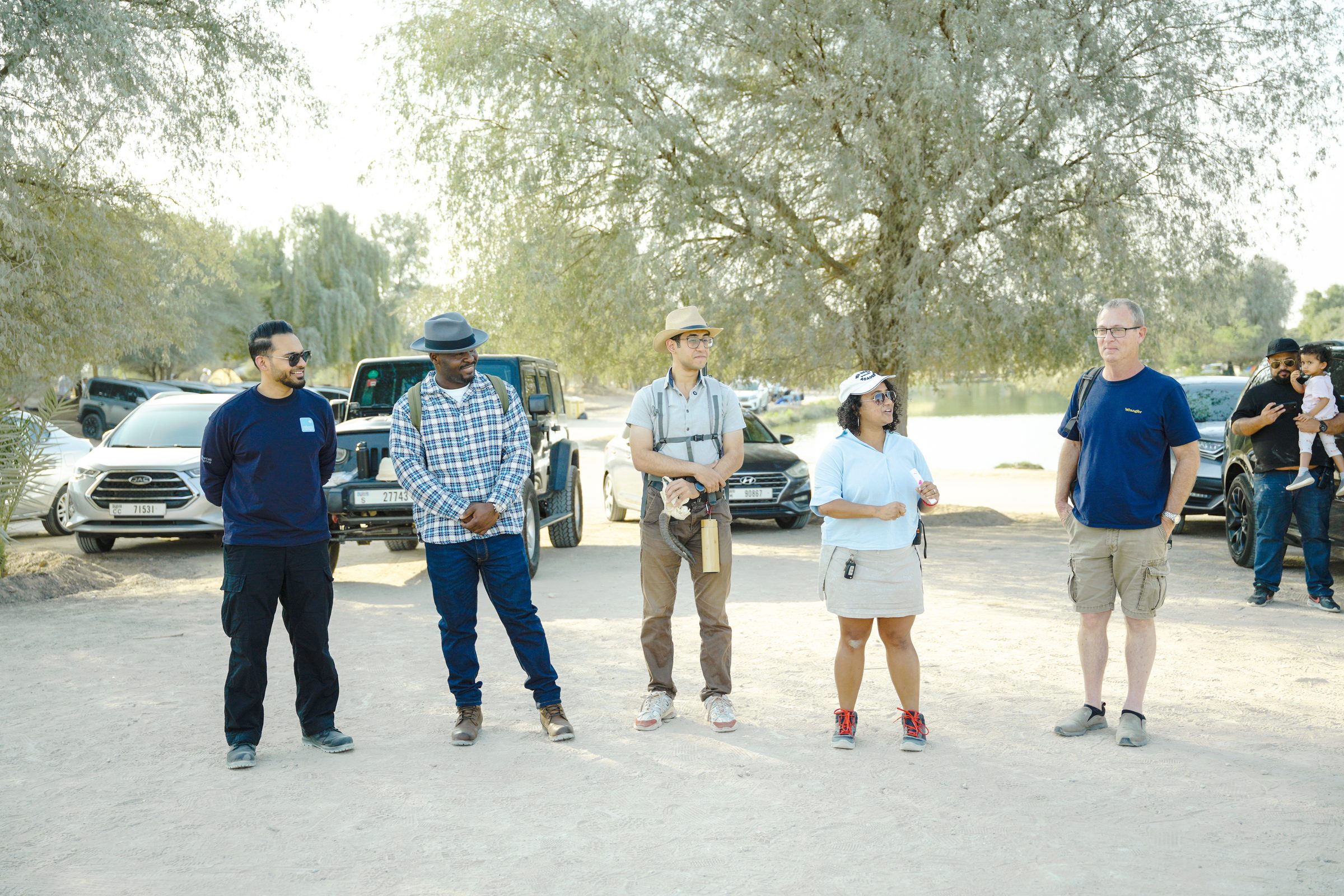 Field discovery — a small group examining a desert skull at golden hour